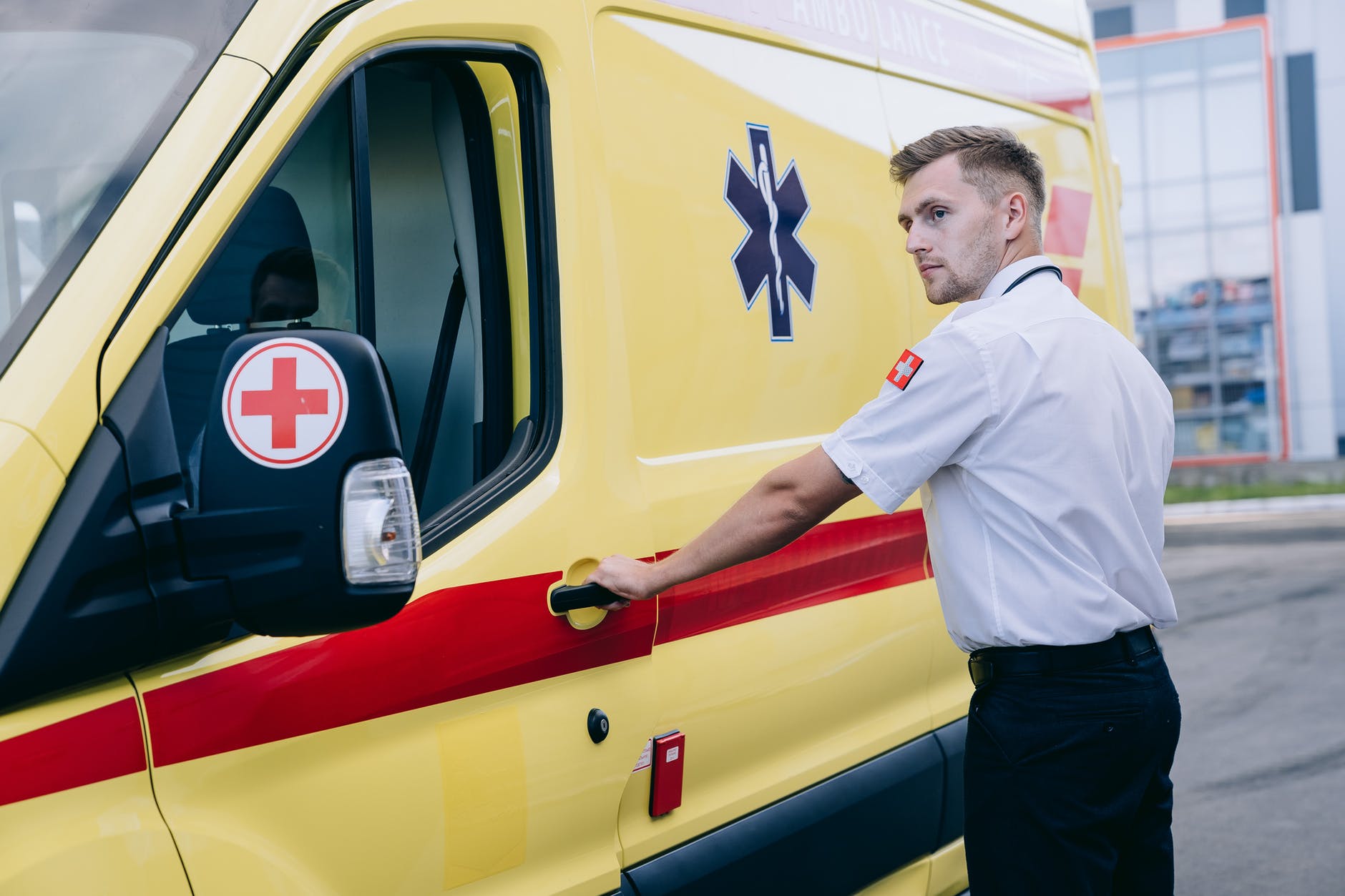 a paramedic holding a car door