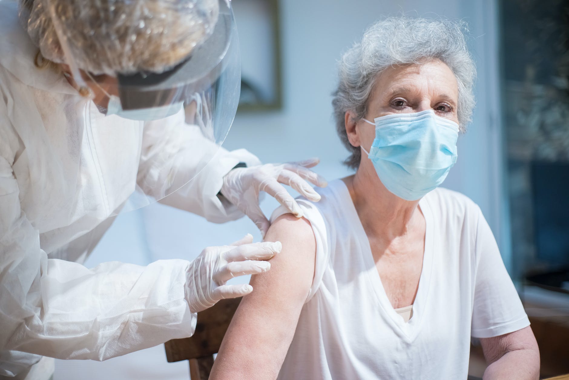 an elderly woman getting a vaccine