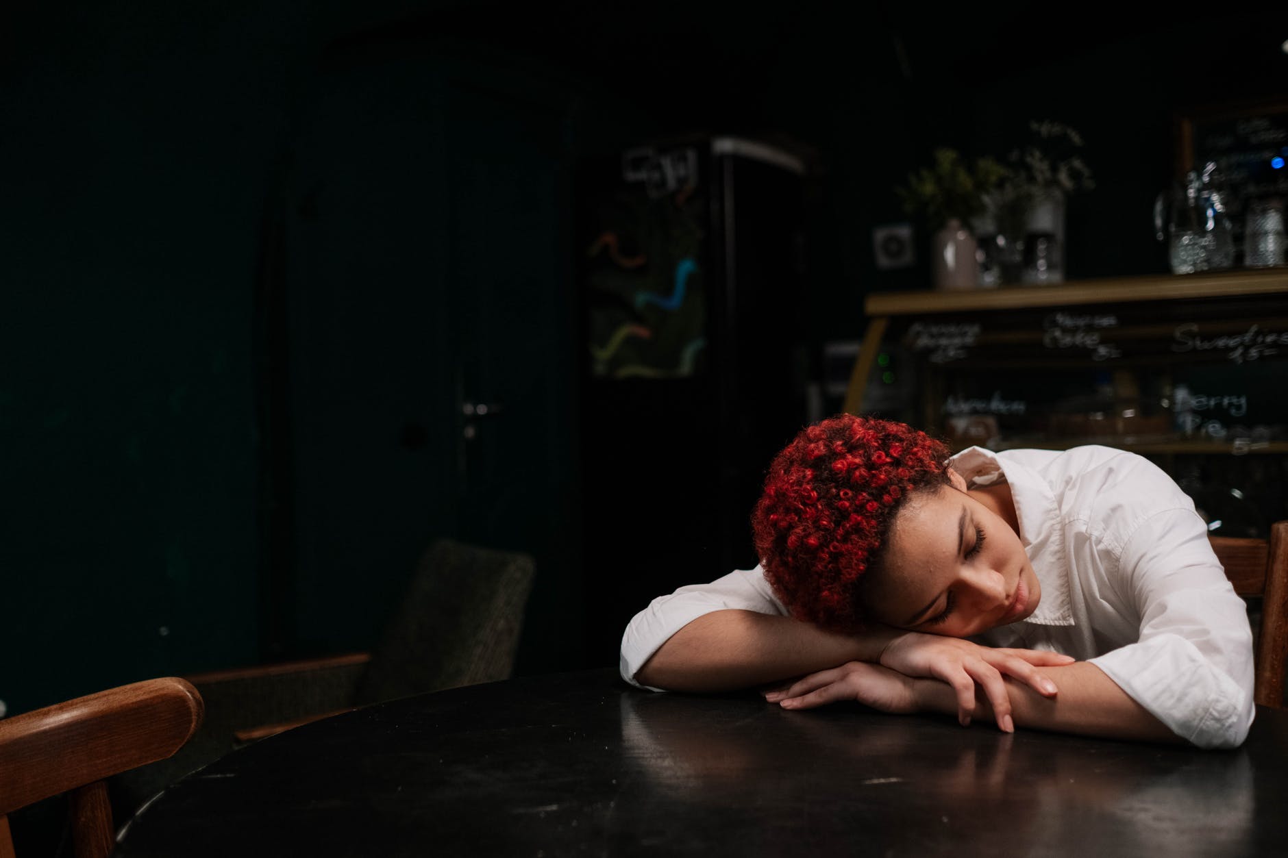 woman sleeping on top of the table