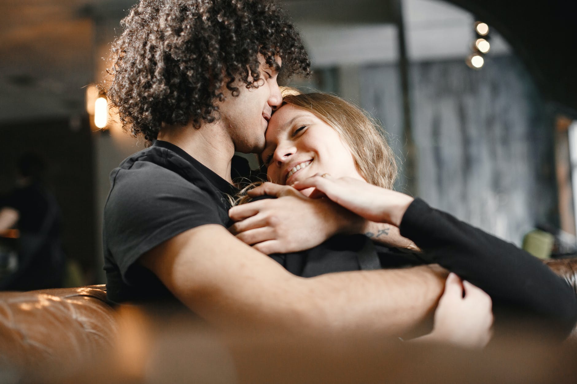boyfriend kissing his girlfriend on forehead