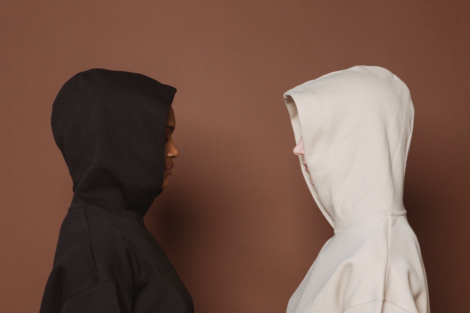 multiethnic women in casual hoodies in studio