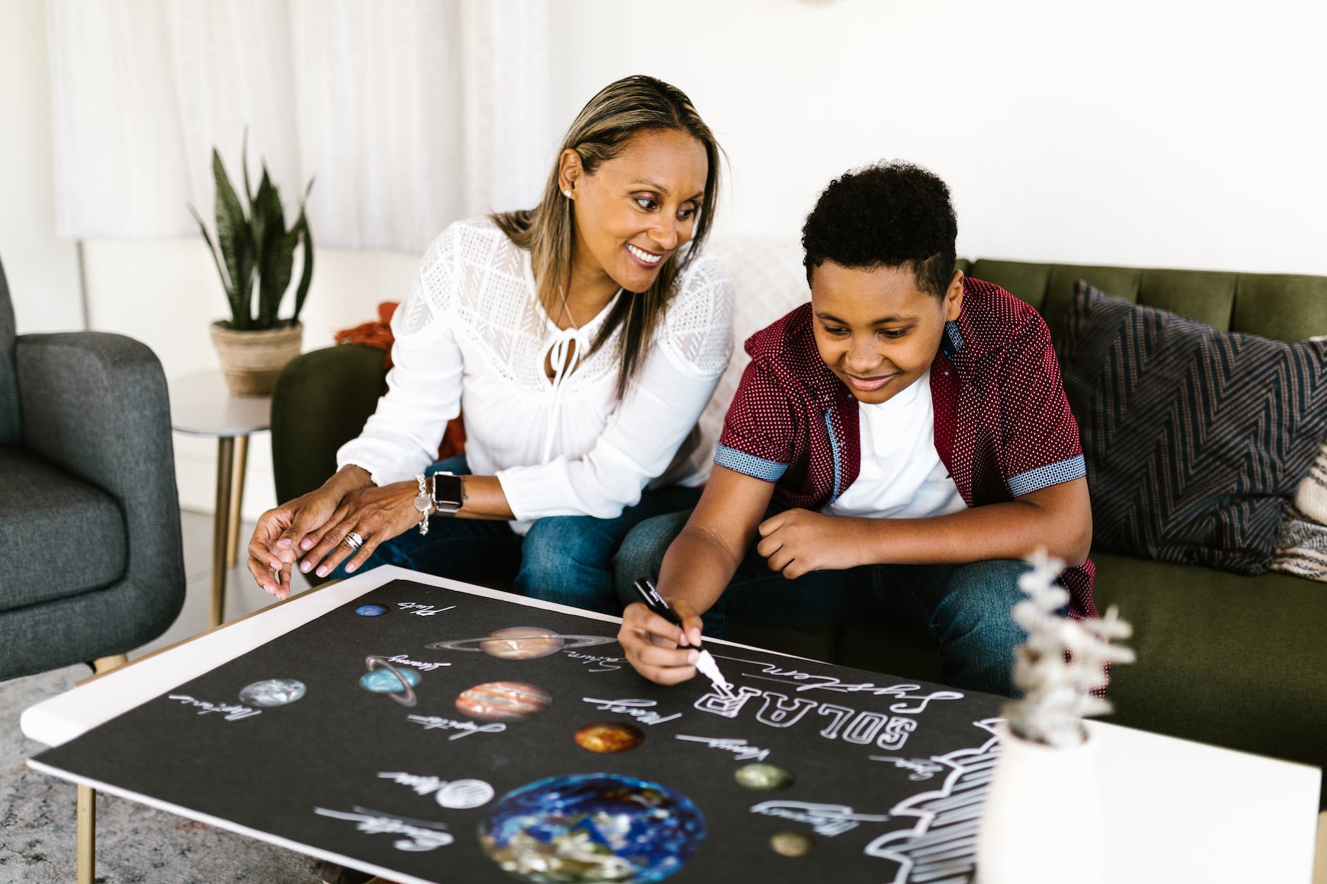a young boy making school project at home