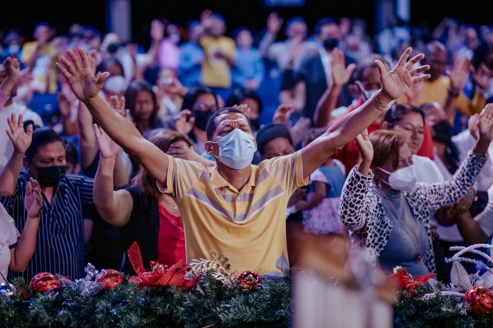 people raising their hands while doing worship