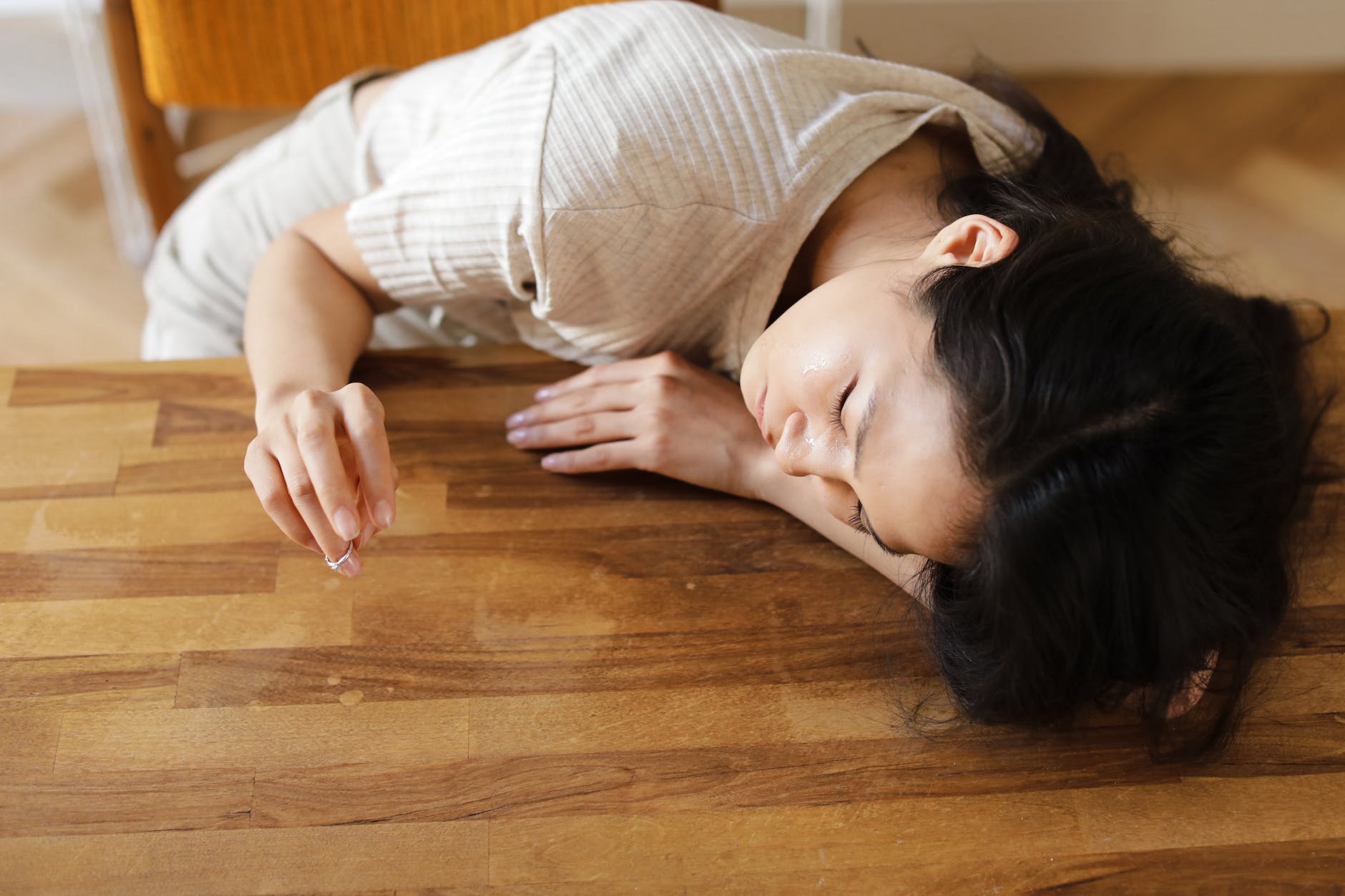 a woman sulking on the wooden table