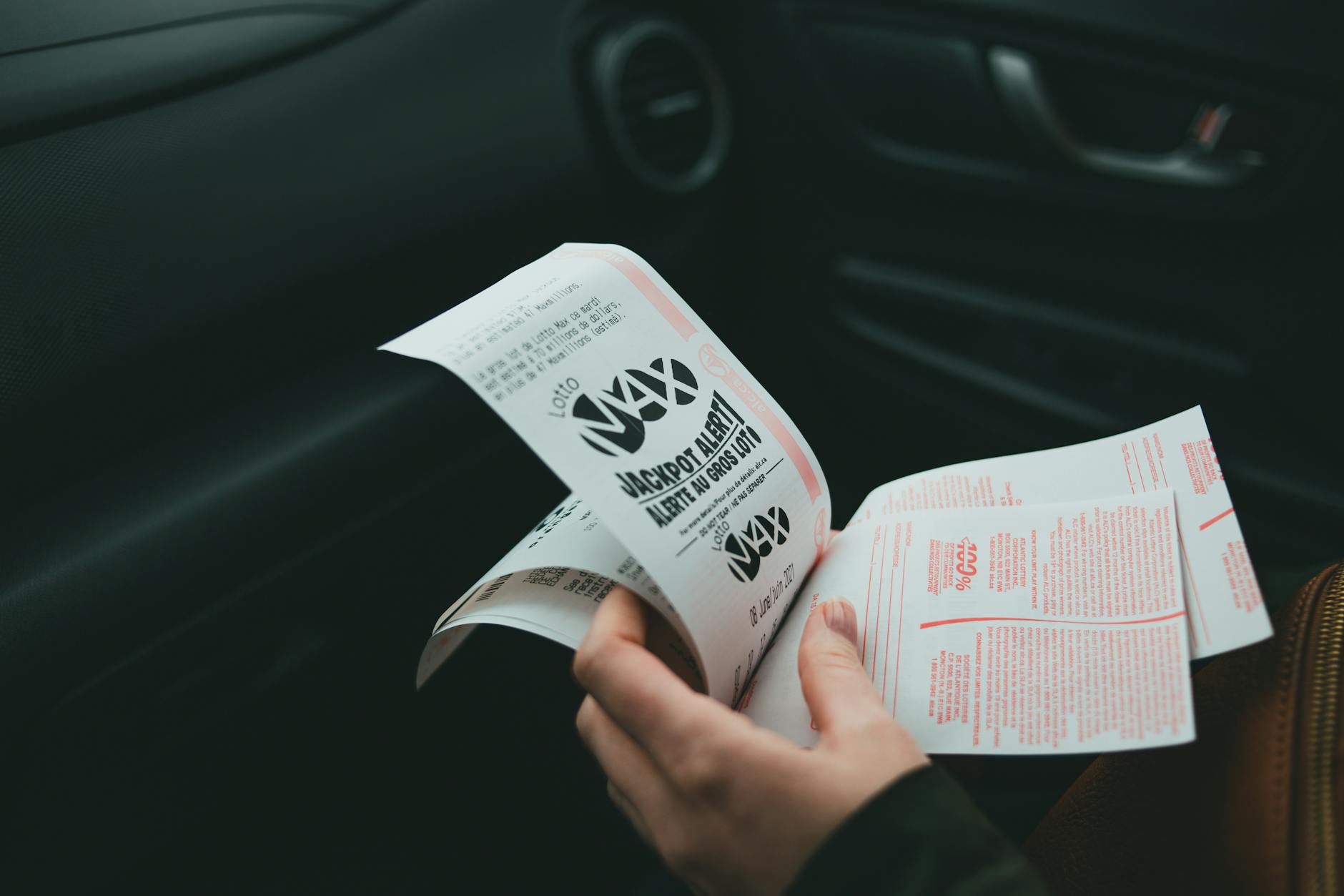 a person holding lottery tickets