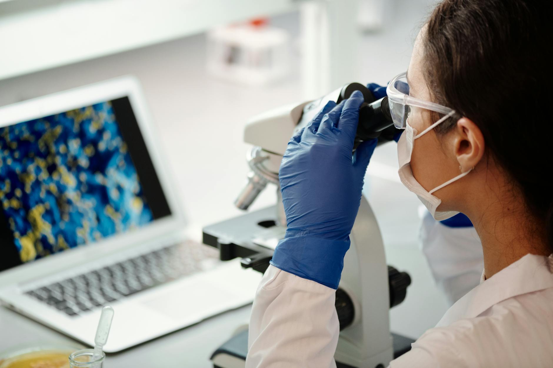 close up photo of medical professional using microscope