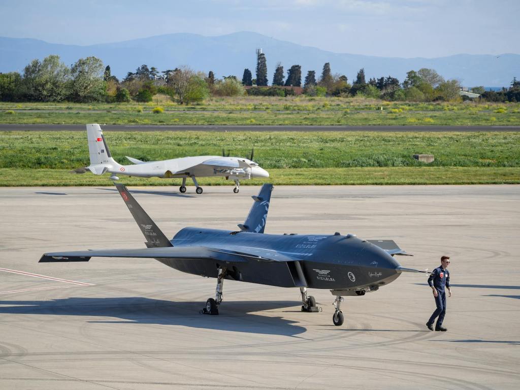 man near fighters on tarmac