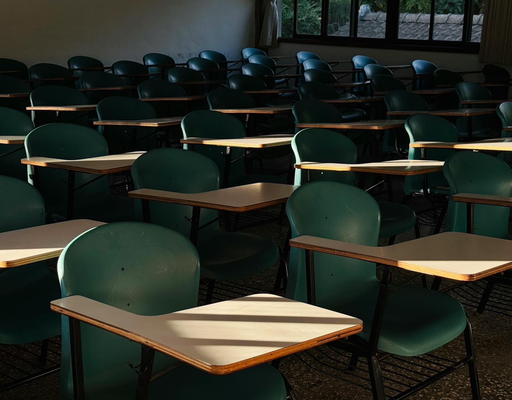 empty classroom with sunlit desks