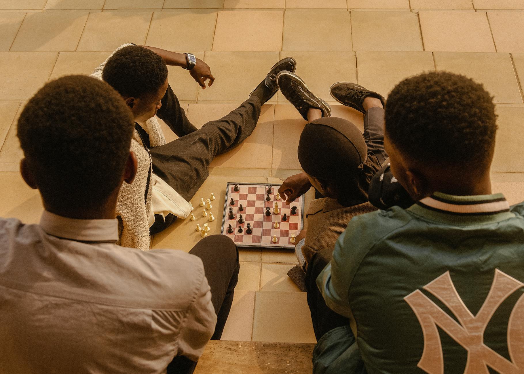 young people playing chess on a sunny day