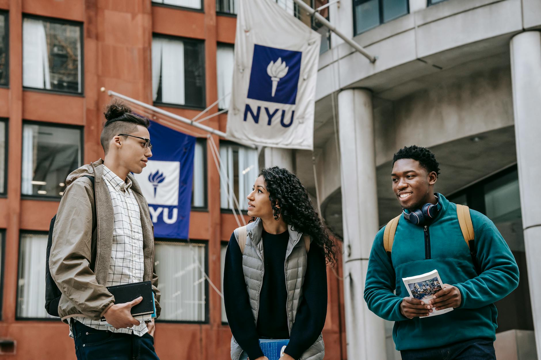 multiethnic students standing near university together