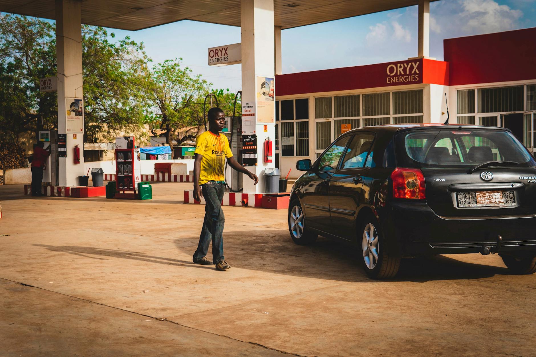 man walking near car