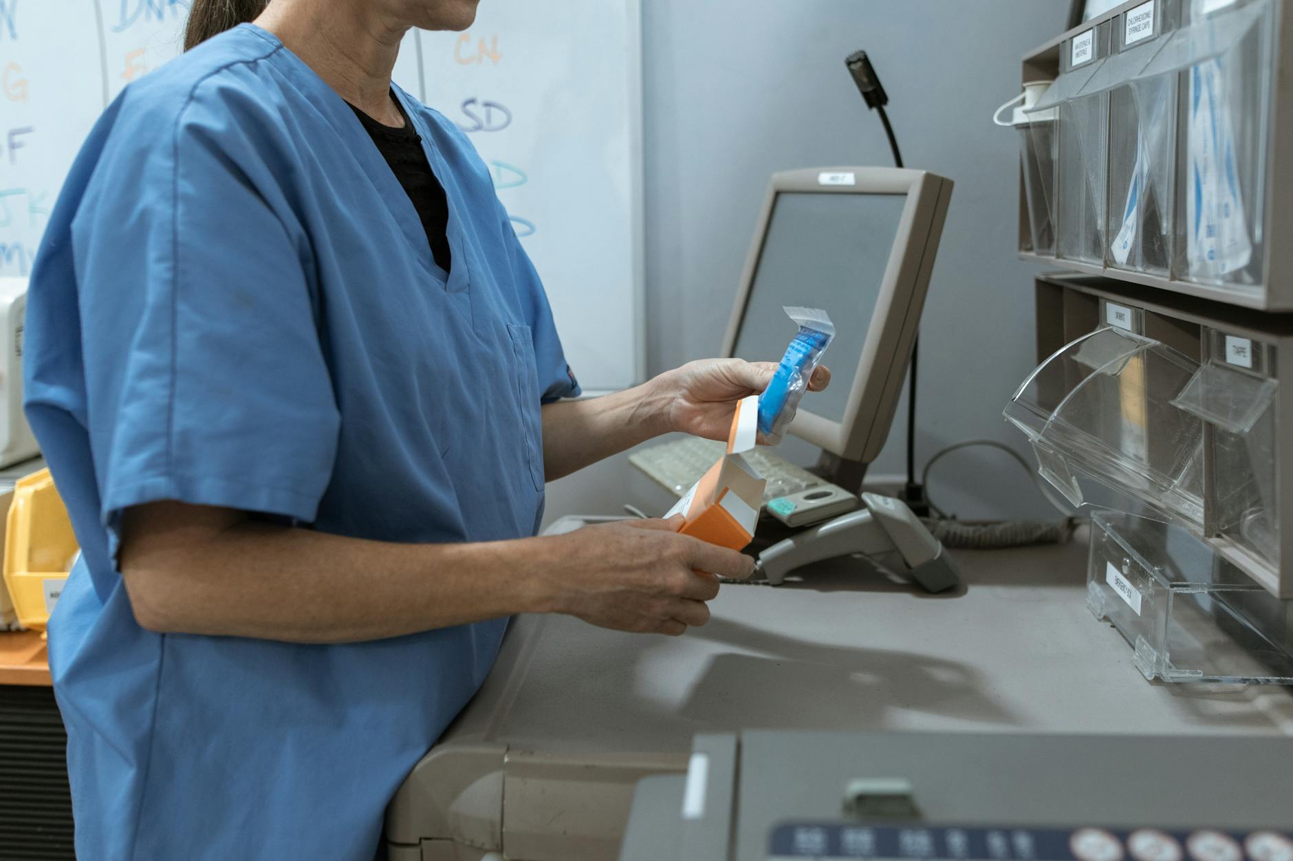 medical practitioner getting medicine from shelf