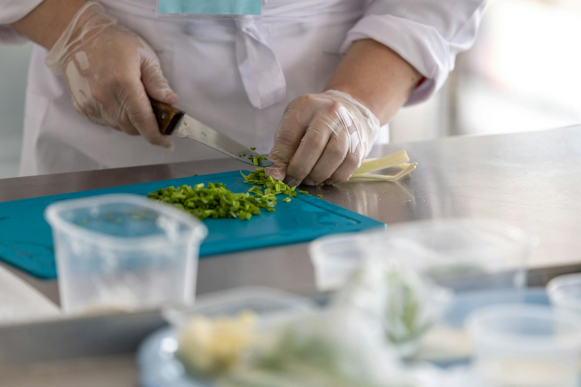 chef preparing fresh herbs in a professional kitchen