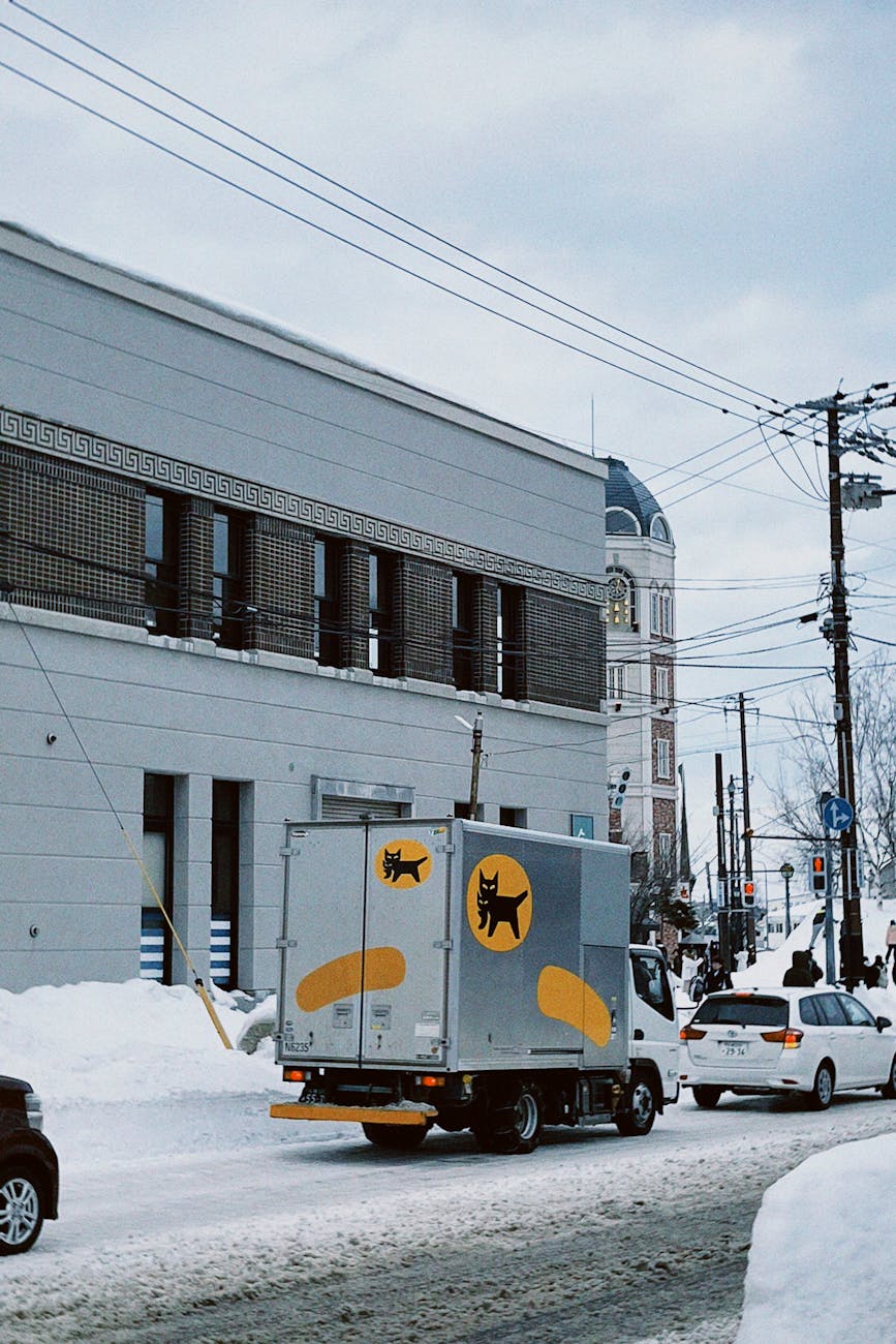 winter street scene with delivery truck in sapporo
