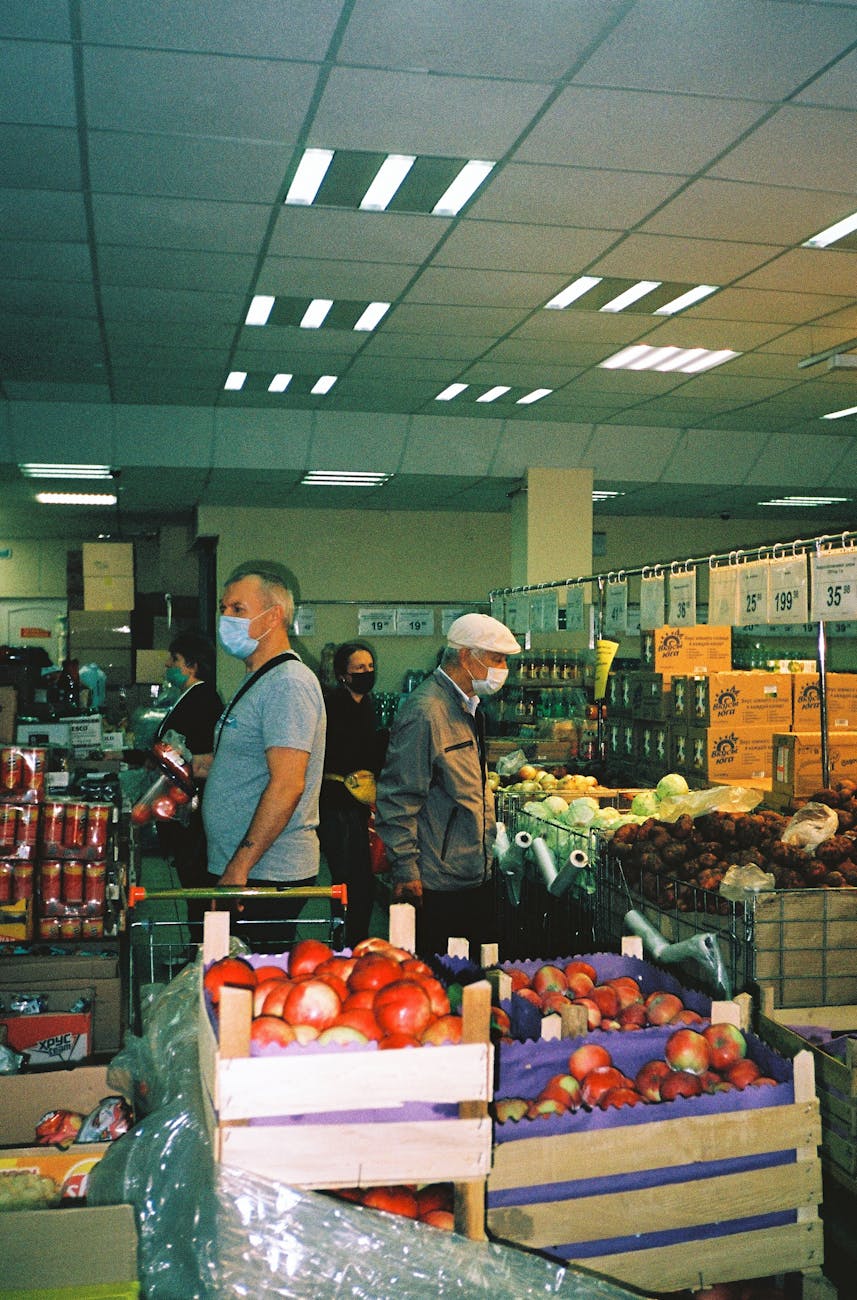people wearing face masks in the grocery store
