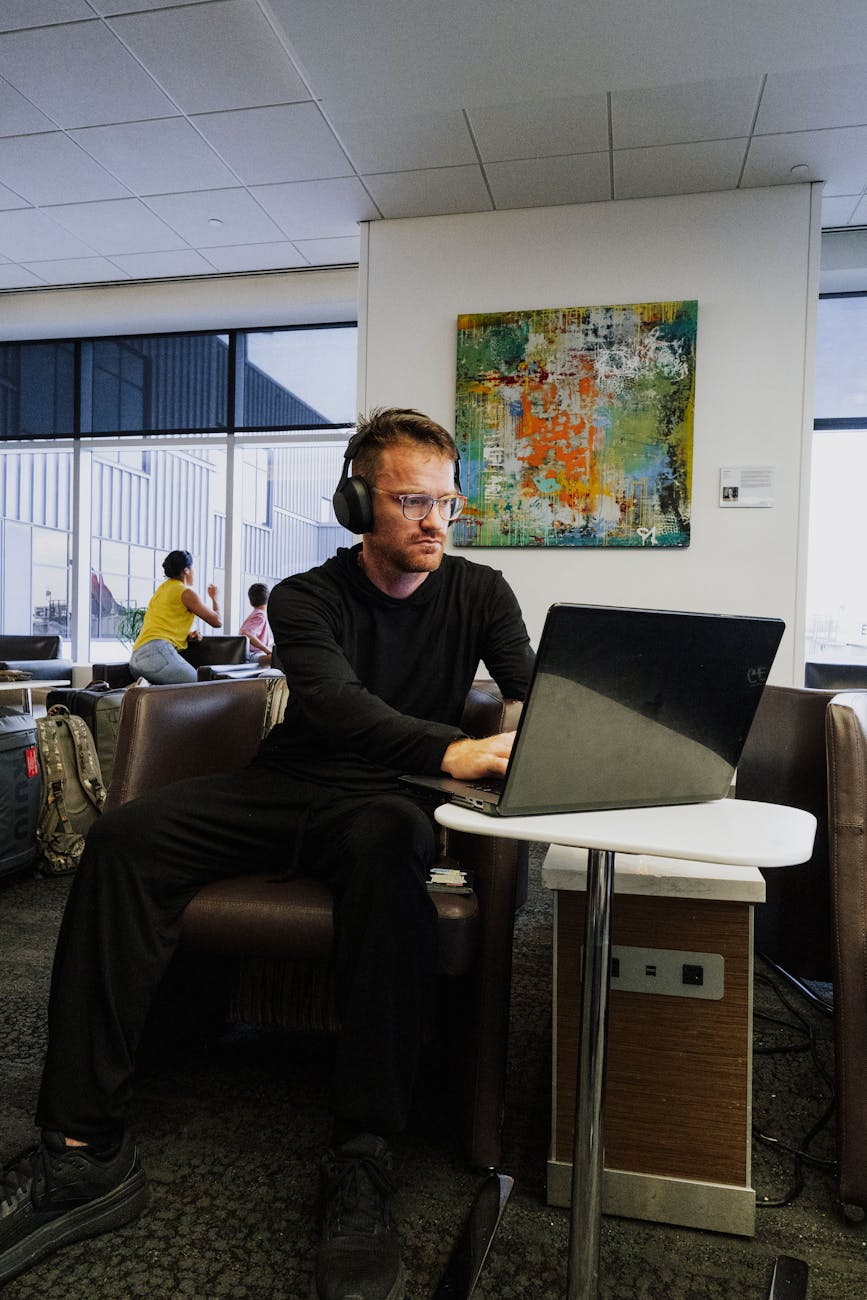 business traveler working with laptop in airport lounge