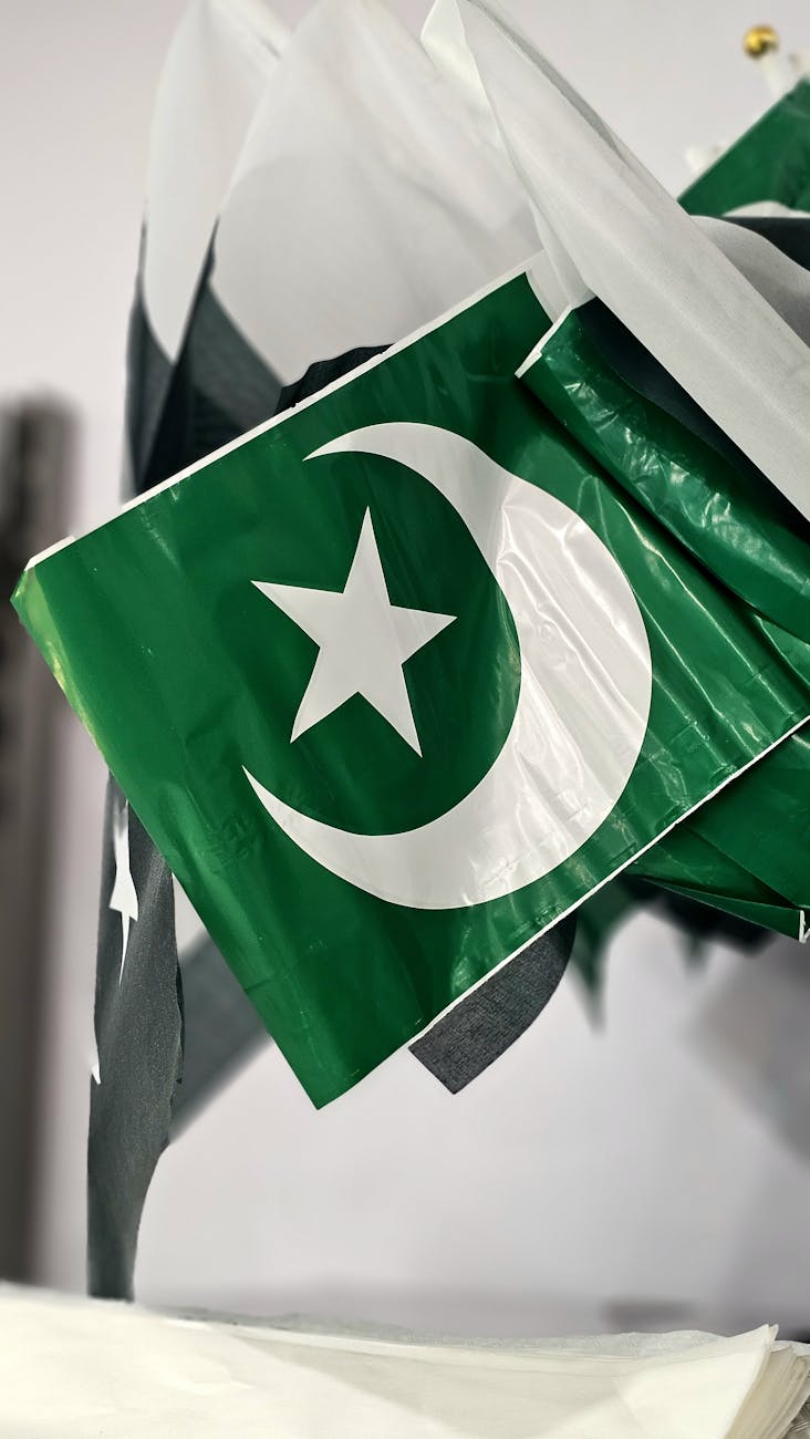 close up of pakistani flags with crescent and star