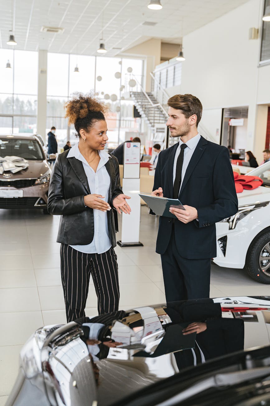 man in business suit discussing with woman in black blazer