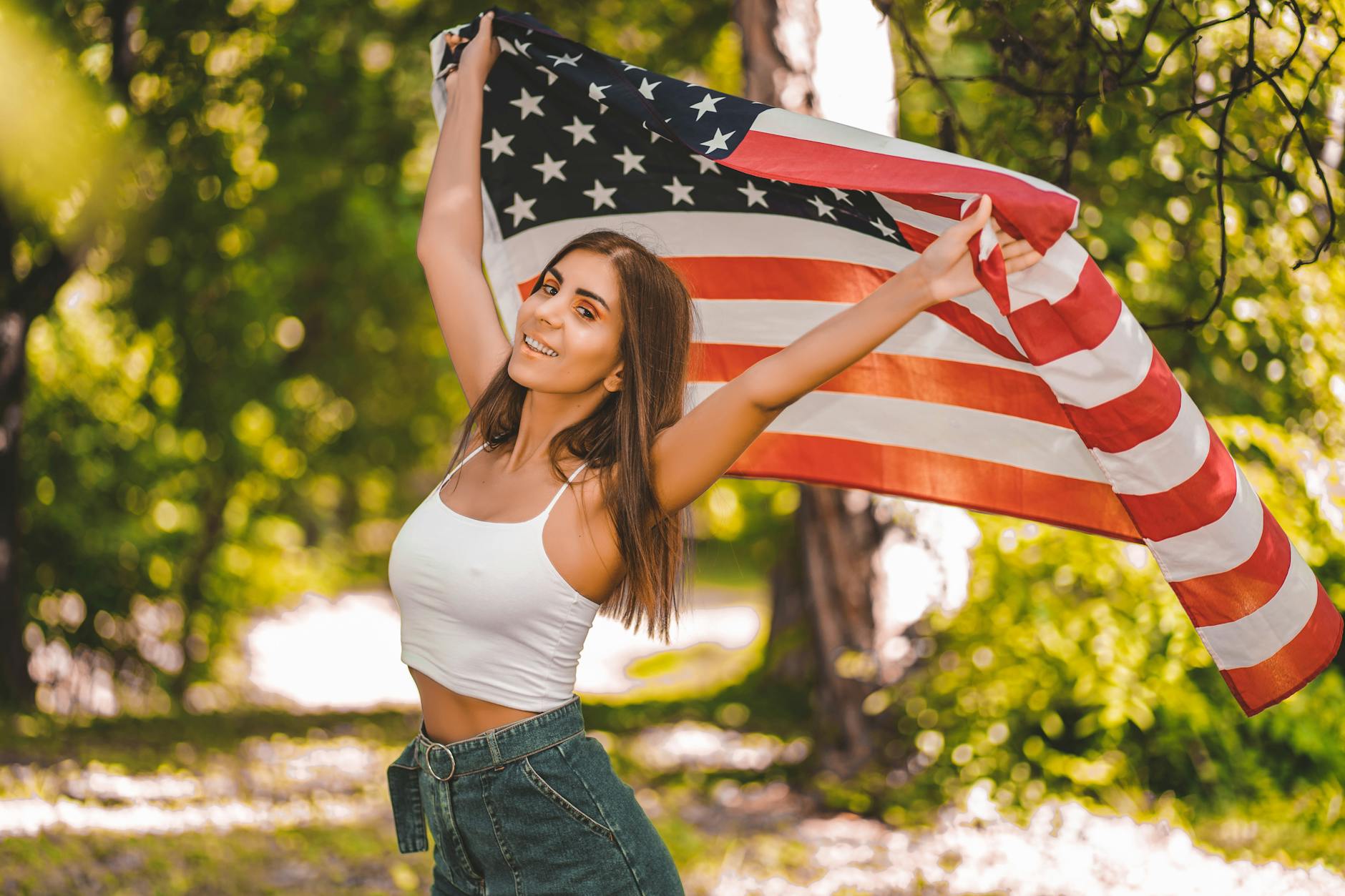 woman in white tank top holding a flag
