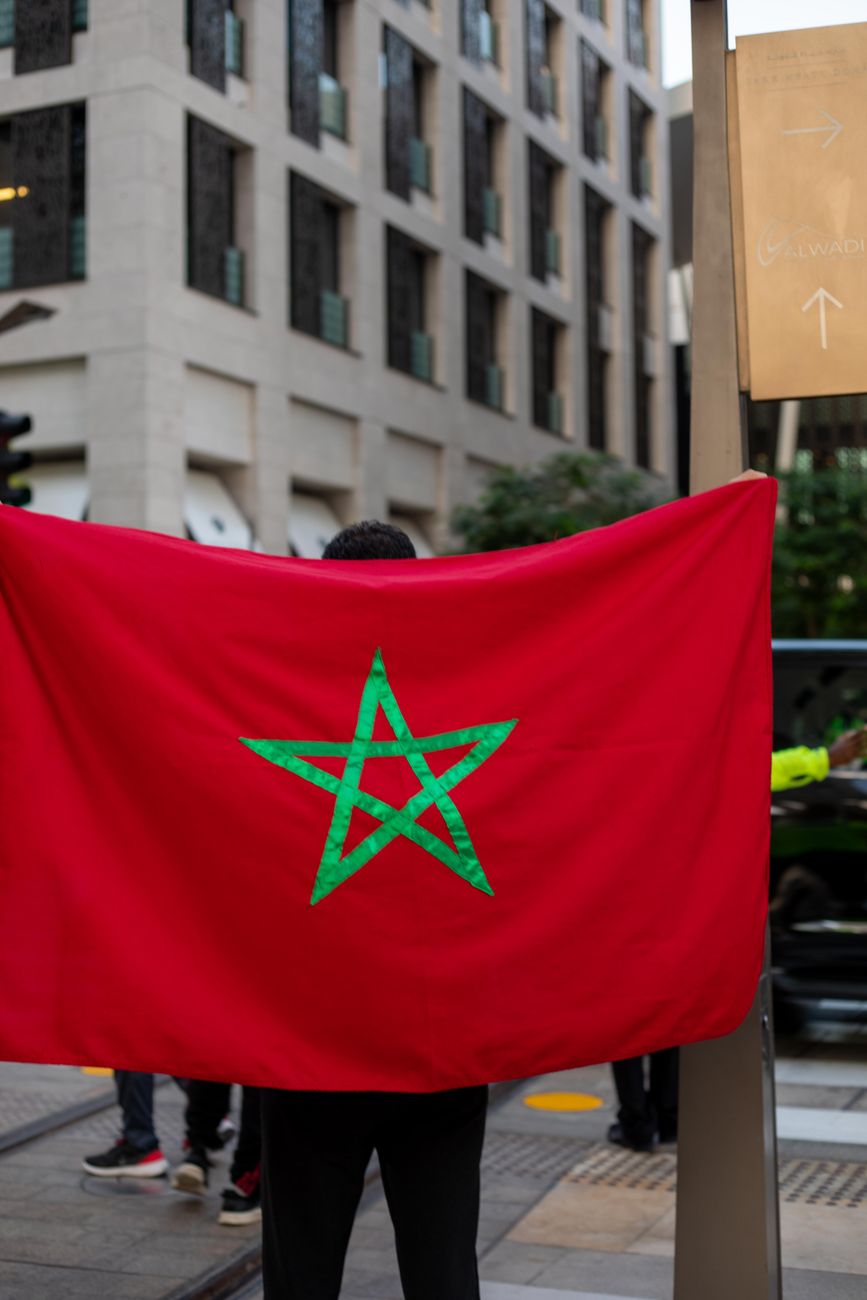 a person carrying a morocco flag