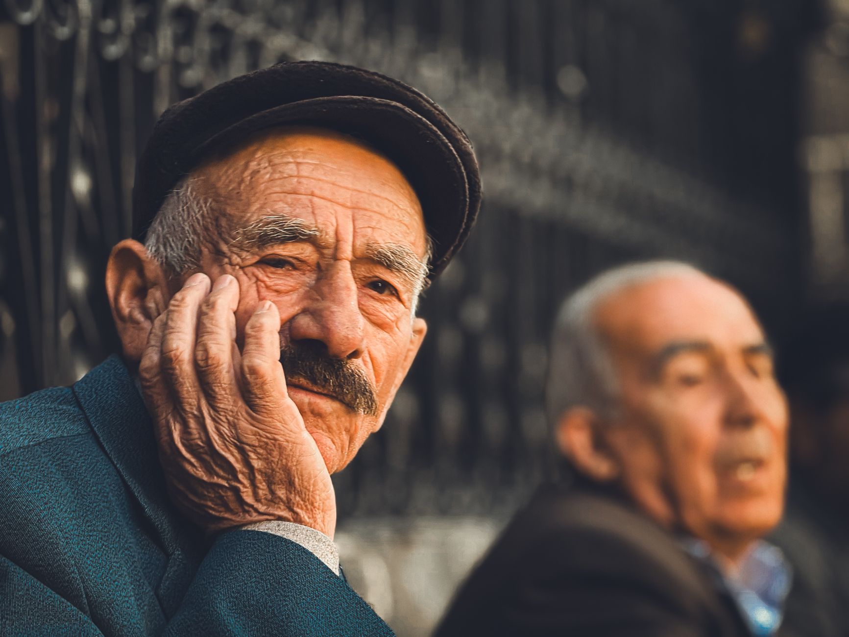 elderly man in thoughtful pose outdoors