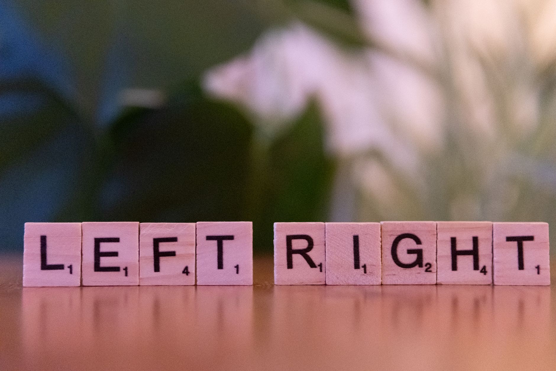 left and right scrabble tiles on wooden surface