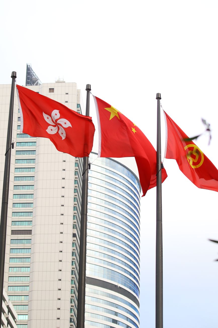 flags of hong kong and china with urban background
