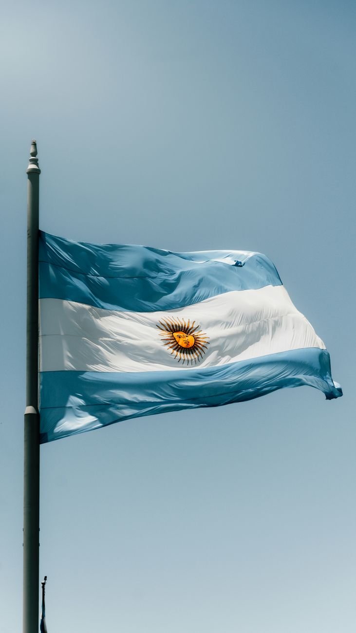 argentinian flag waving against clear blue sky
