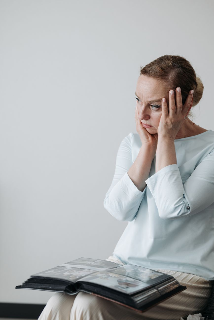 woman with hand s on face looking afar