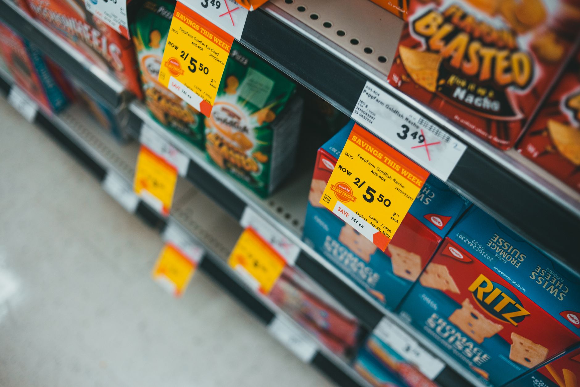 assorted labeled boxes on white shelf