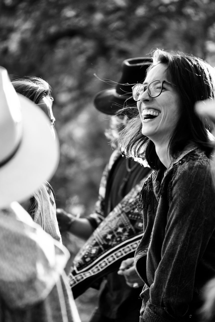 brunette woman with eyeglasses laughing