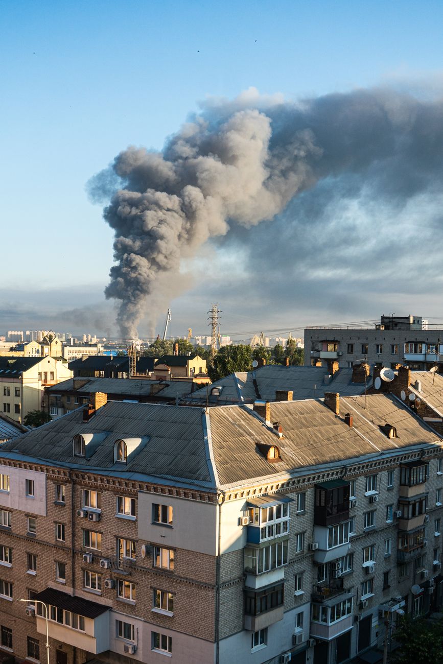 smoke billowing over kyiv cityscape