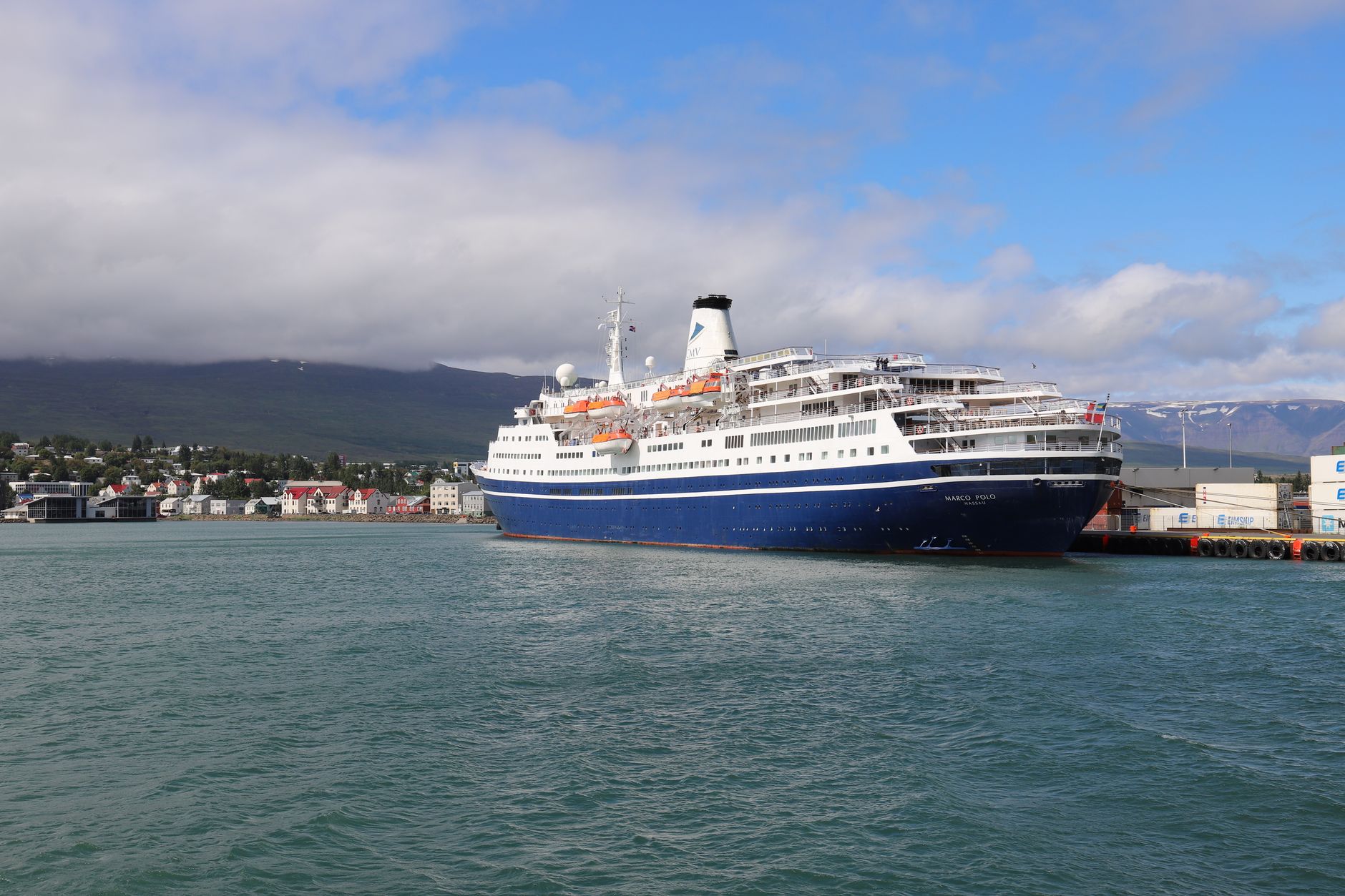 white and blue cruise ship on sea under white clouds