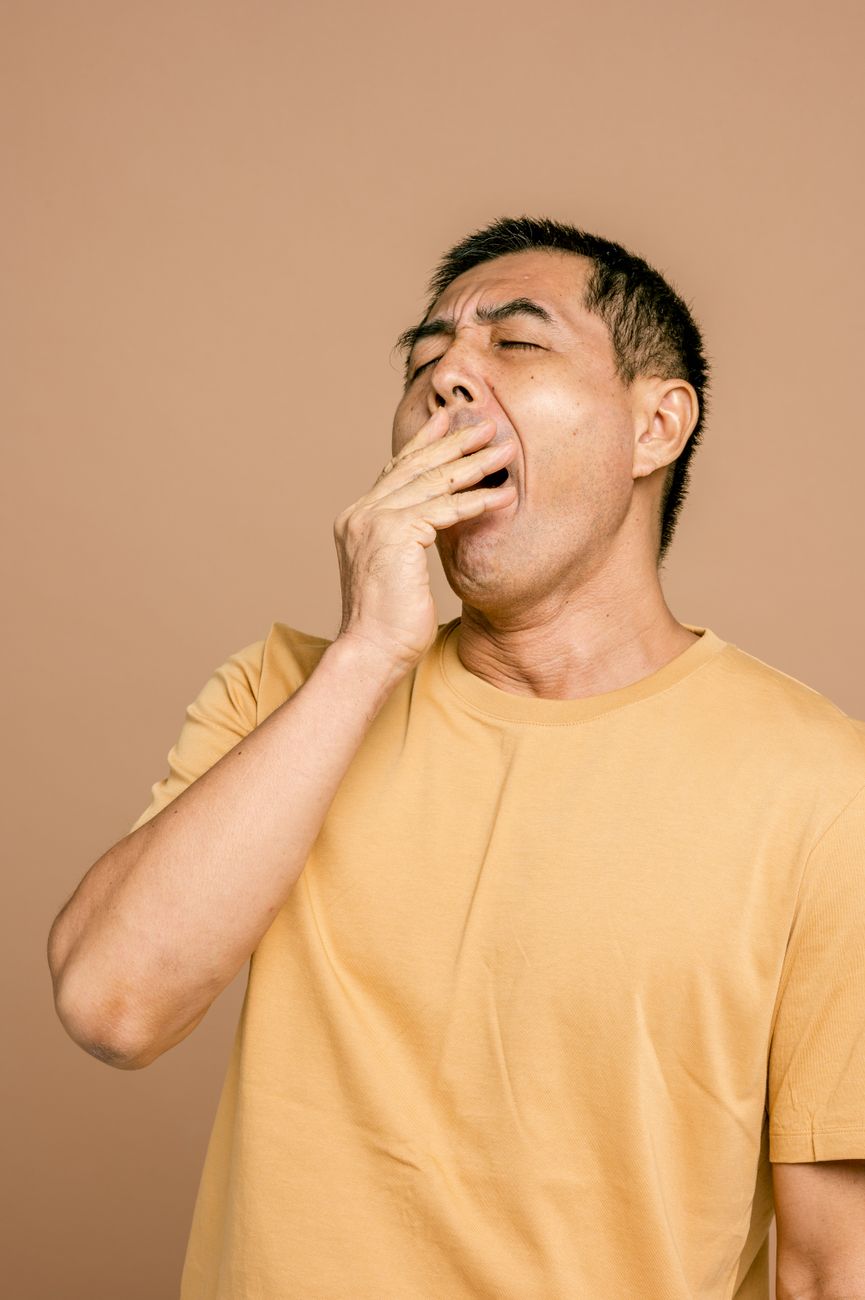 a sleepy man in yellow crew neck t shirt