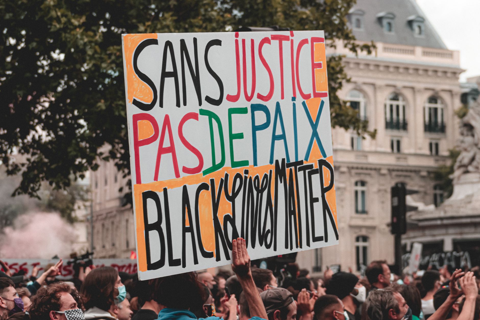 unrecognizable person with sign marching at demonstration