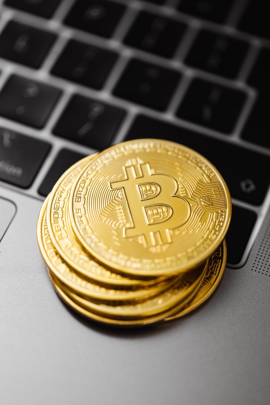 close up of coins stacked on a laptop