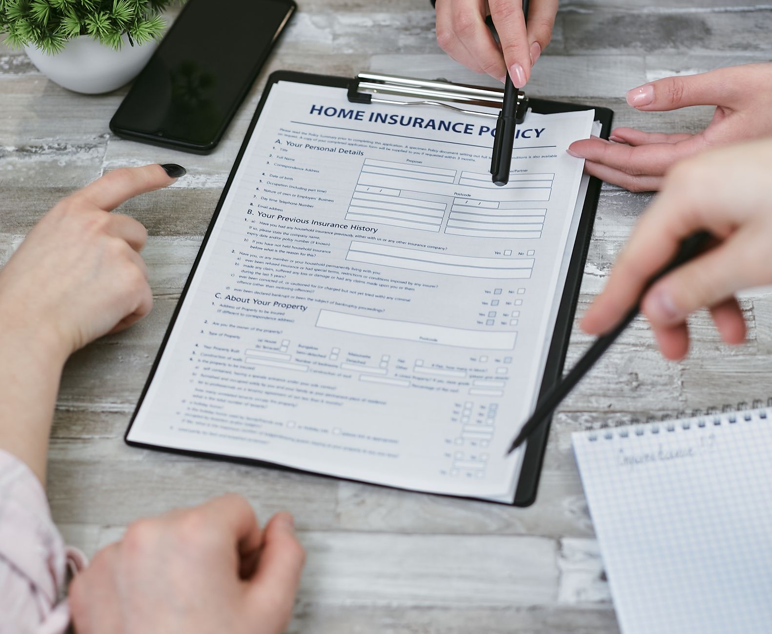 people discussing a home insurance policy